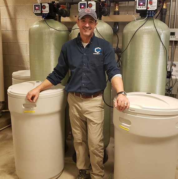 Whole house water purification by technician working with water softeners in Chicago, IL